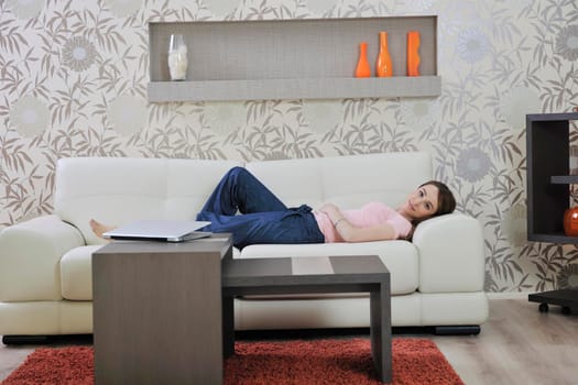 beautiful young woman relaxing on sofa at home