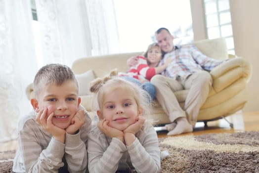 hapy young family have fun  with their children at modern living room home indoors