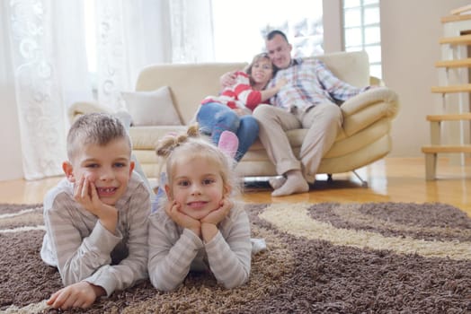 hapy young family have fun  with their children at modern living room home indoors