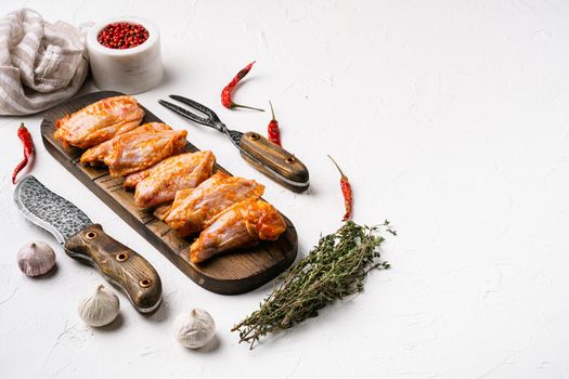 Ready for roasting barbecue wings baffulo set, on white stone table background, with copy space for text