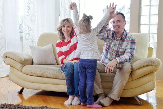 hapy young family have fun  with their children at modern living room home indoors