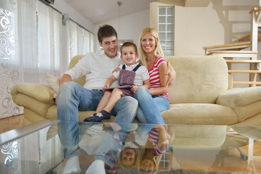 happy young family using tablet computer at modern  home for playing games and education