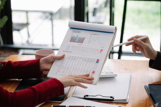 Business People Meeting to analyse and discuss and brainstorming the financial report chart data in office Financial advisor teamwork and accounting concept.