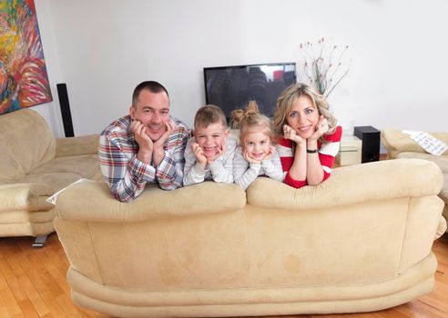 hapy young family have fun  with their children at modern living room home indoors