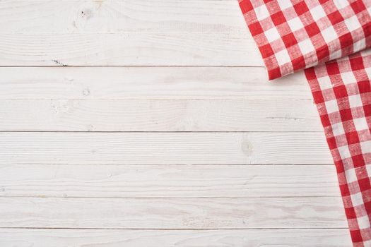 Red checkered tablecloth wooden background texture kitchen decoration. High quality photo