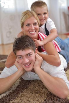 happy young family with kids in bright modern living room have fun and looking big flat lcd tv