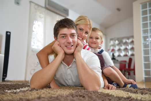 happy young family with kids in bright modern living room have fun and looking big flat lcd tv