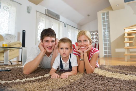 happy young family with kids in bright modern living room have fun and looking big flat lcd tv