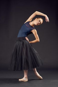 women ballerina in a black dress dance fashion exercise isolated background. High quality photo