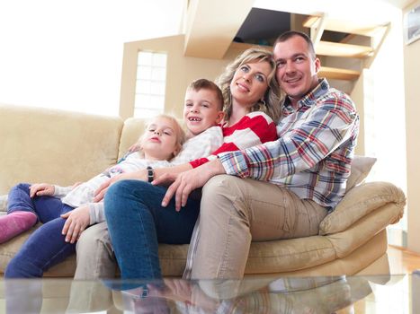 hapy young family have fun  with their children at modern living room home indoors