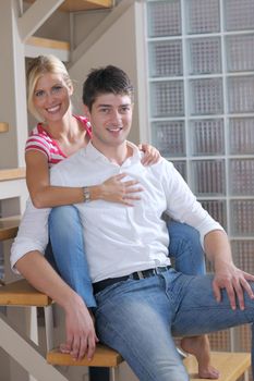 Relaxed young  couple watching tv at home in bright living room