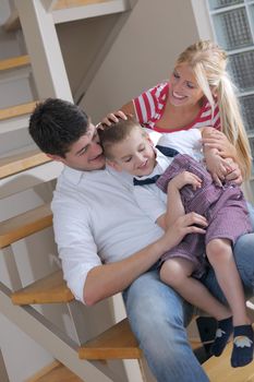 happy young family with kids in bright modern living room have fun and looking big flat lcd tv