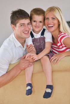 happy young family with kids in bright modern living room have fun and looking big flat lcd tv