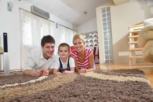 happy young family with kids in bright modern living room have fun and looking big flat lcd tv