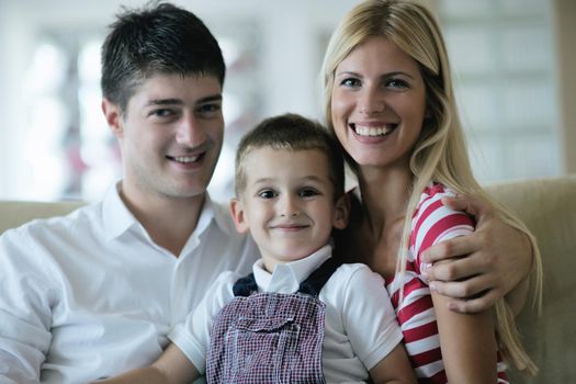 happy young family with kids in bright modern living room have fun and looking big flat lcd tv