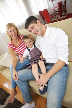 happy young family using tablet computer at modern  home for playing games and education