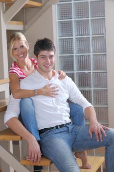 Relaxed young  couple watching tv at home in bright living room