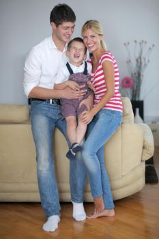 happy young family using tablet computer at modern  home for playing games and education