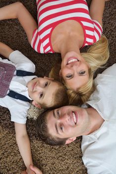 happy young family with kids in bright modern living room have fun and looking big flat lcd tv