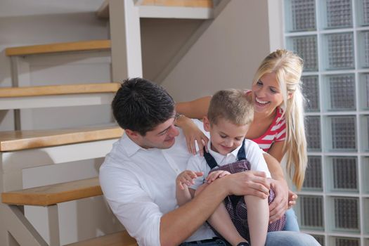 happy young family with kids in bright modern living room have fun and looking big flat lcd tv