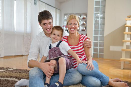 happy young family using tablet computer at modern  home for playing games and education