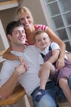 happy young family with kids in bright modern living room have fun and looking big flat lcd tv