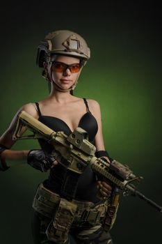 soldier girl poses with an automatic rifle