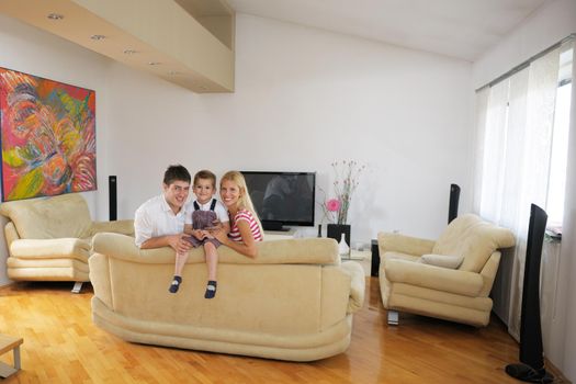 happy young family with kids in bright modern living room have fun and looking big flat lcd tv