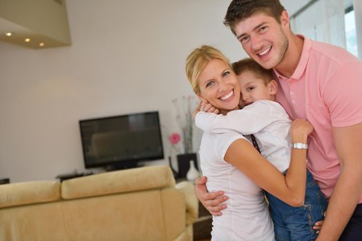 happy young family with kids in bright modern living room have fun and looking big flat lcd tv