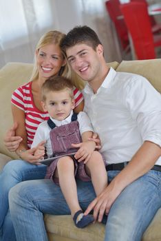 happy young family with kids in bright modern living room have fun and looking big flat lcd tv