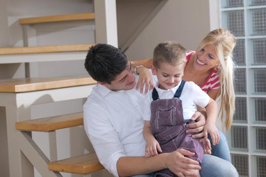 happy young family with kids in bright modern living room have fun and looking big flat lcd tv