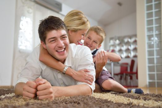 happy young family with kids in bright modern living room have fun and looking big flat lcd tv