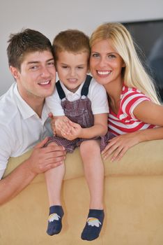 happy young family with kids in bright modern living room have fun and looking big flat lcd tv