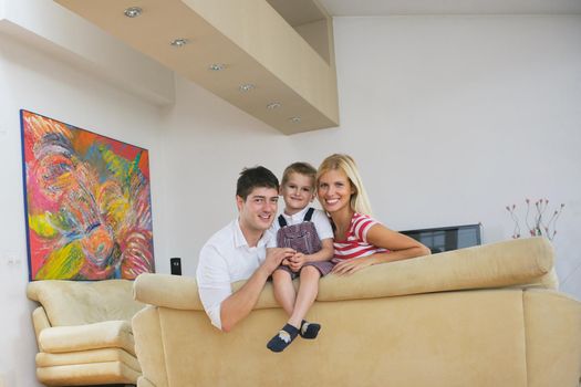 happy young family with kids in bright modern living room have fun and looking big flat lcd tv