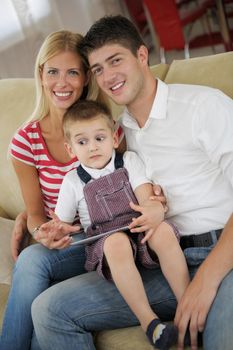 happy young family using tablet computer at modern  home for playing games and education