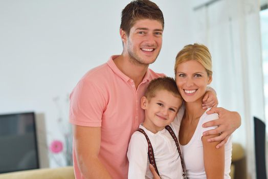 happy young family with kids in bright modern living room have fun and looking big flat lcd tv