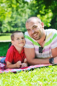 family father and son have fun at park on summer season and representing happines concept