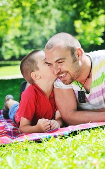 family father and son have fun at park on summer season and representing happines concept