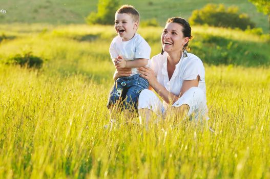 happy young woman mother play and outdoor with beautiful child