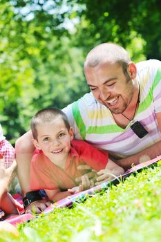 family father and son have fun at park on summer season and representing happines concept