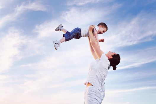 happy young woman mother play and outdoor with beautiful child 