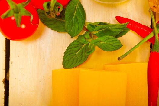 Italian pasta paccheri or schiaffoni with tomato mint and chili pepper ingredients