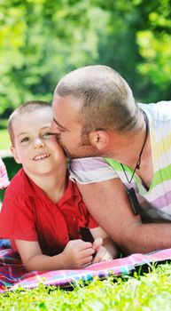 family father and son have fun at park on summer season and representing happines concept