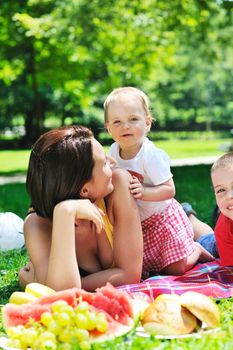 happy young woman and baby have fun while playing in beautiful bright park at summer season