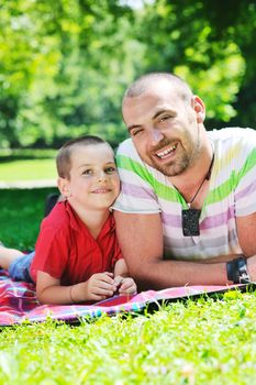 family father and son have fun at park on summer season and representing happines concept