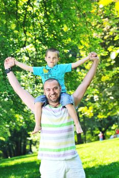 family father and son have fun at park on summer season and representing happines concept