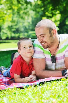 family father and son have fun at park on summer season and representing happines concept