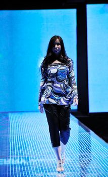 beautiful young fashion model woman walking on fashion show event 