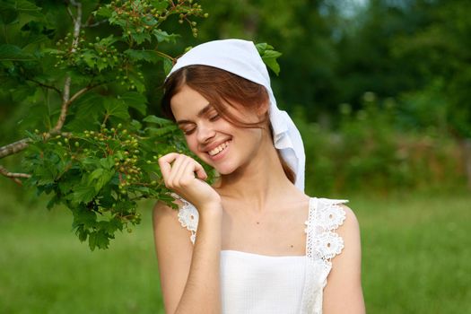 Woman in white dress in the village outdoors Green grass Farmer. High quality photo