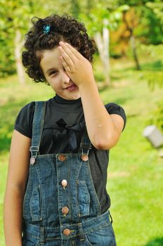 child fashion with beautiful little child outdoor in nature